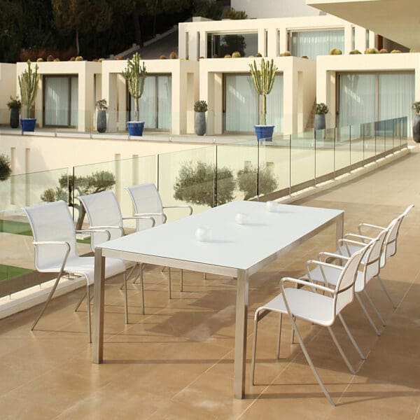 Image of white and stainless steel Taboela garden table & QT55 chairs on terrace by Royal Botania