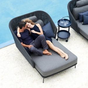Image of couple canoodling on Mega twin daybed by Cane-line on chic poolside