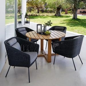 Image of 4 Mega black rattan garden chairs around Endless round teak table by Cane-line