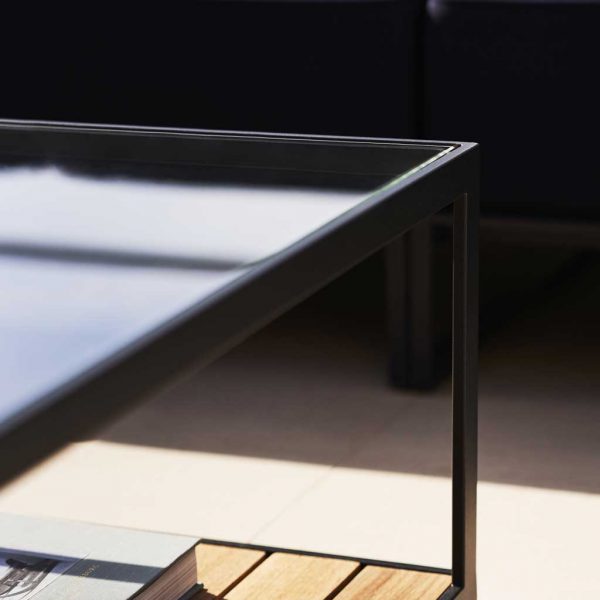 Image of detail of glass table top and linear steel frame of Moore outdoor low table by Roshults