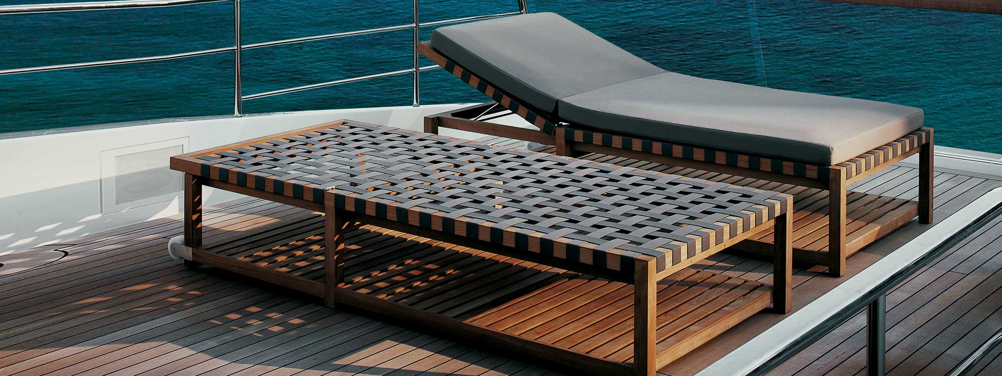 Image of pair of RODA Network teak sunbeds with Brown webbing and Brown cushion on deck of superyacht