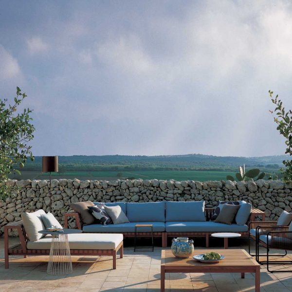 Image of RODA Network modern teal sofa with blue cushions, and Network teak chaise longue with white cushions