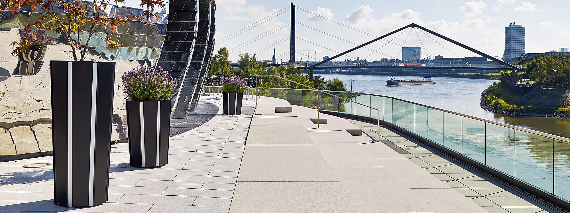 Image of Flora Octa large outdoor planters on sunny terrace overlooking a bridge & large river in Germany