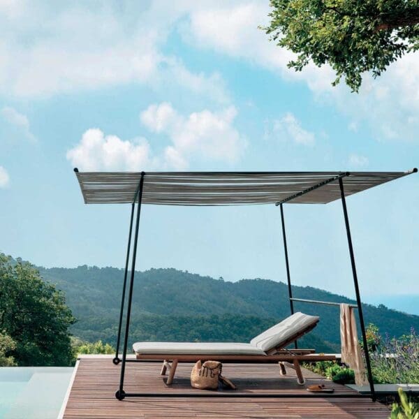 Image of Orson teak sunbed beneath Ombrina pergola, beside swimming pool