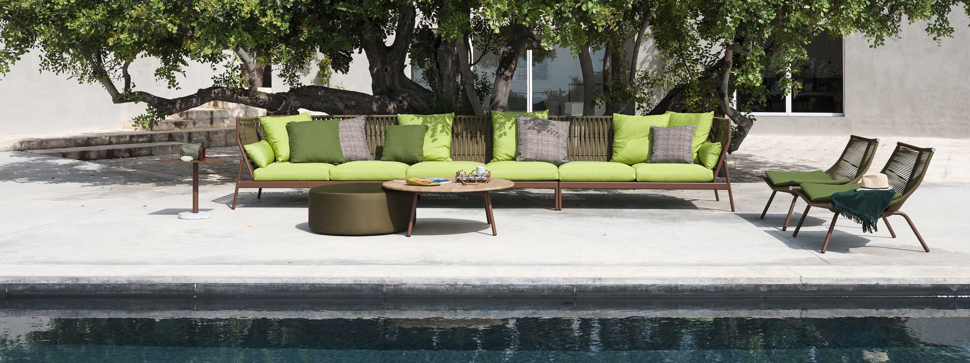 Image of Piper high back garden sofa with rust-colored frame and poison green cushions by RODA
