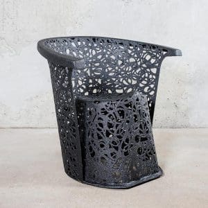 Image of side view of black Race garden armchair by Unknown Nordic shown against concrete background