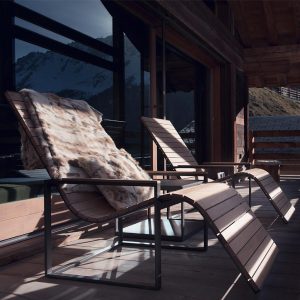 Image of Roshults Garden Sun Chairs on balcony with fleece thrown over the back of one chair