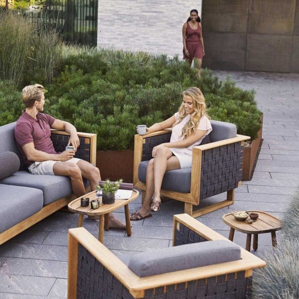Image of Angle upholstered teak sofa and lounge chair with Royal Teak low tables by Cane-line garden furniture