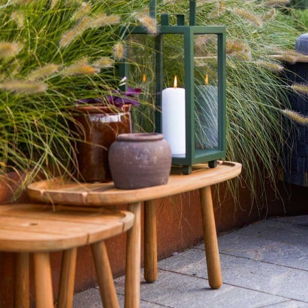 Image of 2 different sizes of Royal Teak low tables and Lighthouse garden lantern by Cane-line outdoor furniture