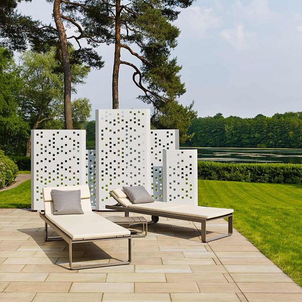 Image of Separo modern outdoor screens by Flora, shown in terrace with sun loungers, with trees, woodland and a lake in the background