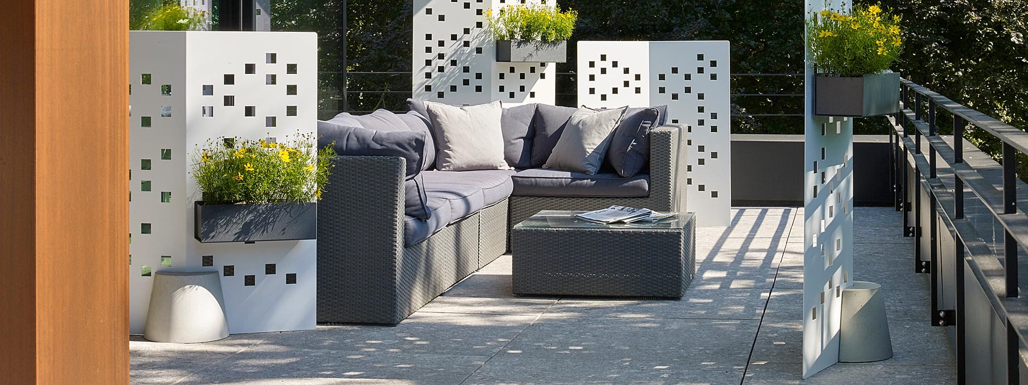 Image of Separo Solo free-standing white garden screens by Flora, shown in different sizes around a garden sofa