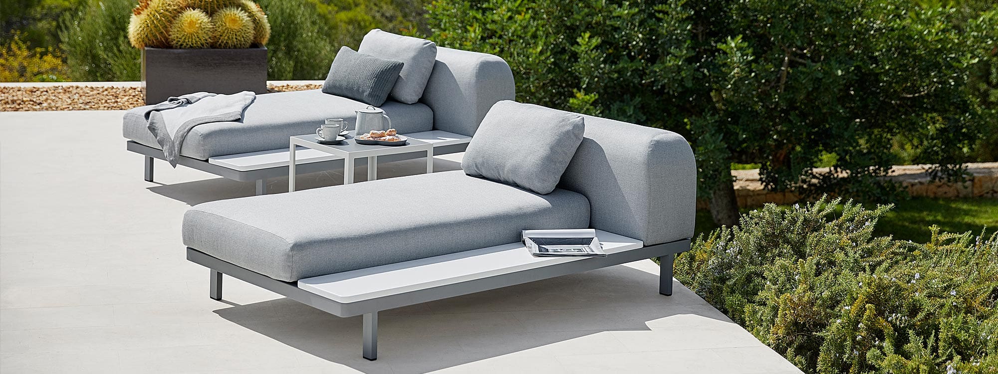 Image demonstrating how Cane-line Space garden sofa modules can be configured into daybeds