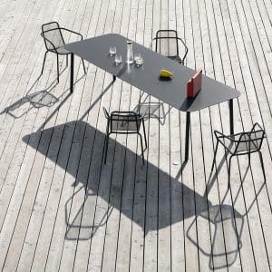 Image of Starling modern garden dining set, casting shadow on sunny wooden decking