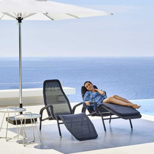 Image of Sunrise reclining garden chairs by Caneline, shown next to swimming pool