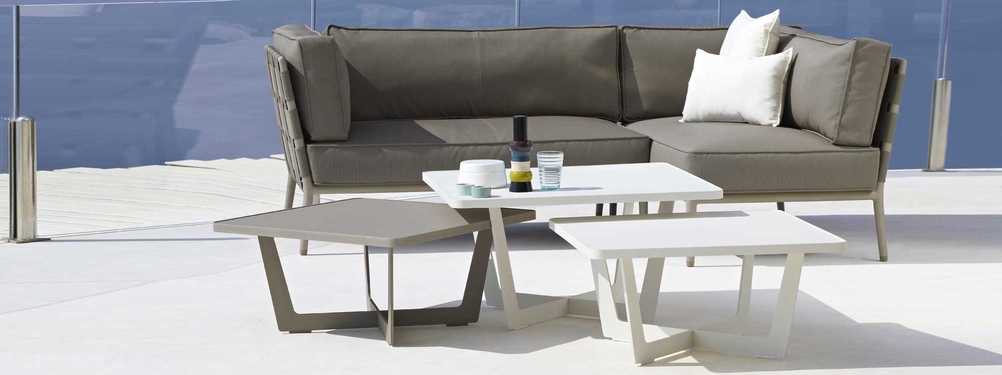 Image of Time Out outdoor low tables and Conic garden sofa by Caneline furniture