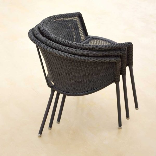 Image of stacked Trinity garden chairs by Cane-line furniture