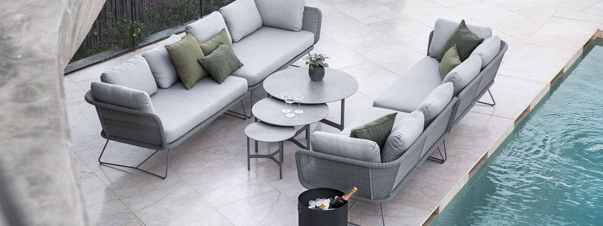 Image of pair of Horizon rattan garden sofas and light grey Twist outdoor low tables by Cane-line