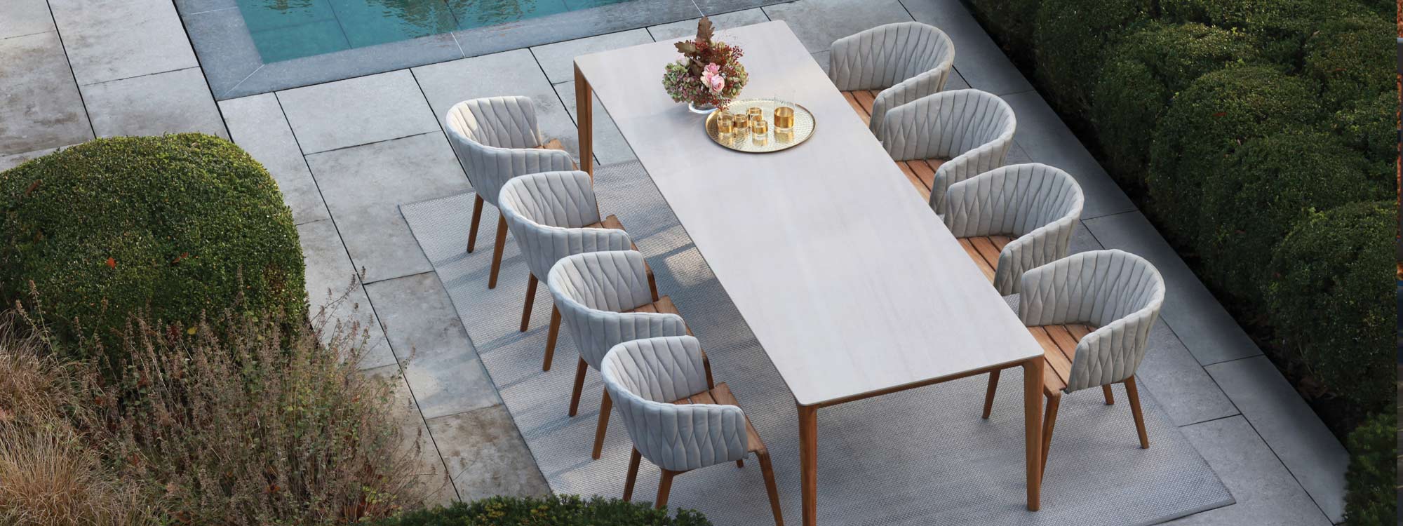 Image of Calypso garden chairs and U-nite teak dining table with ceramic top by Royal Botania