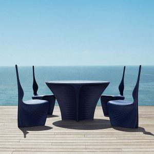 Image of Vondom Biophilia modern black garden dining furniture on wooden decking with sea and sky in the background