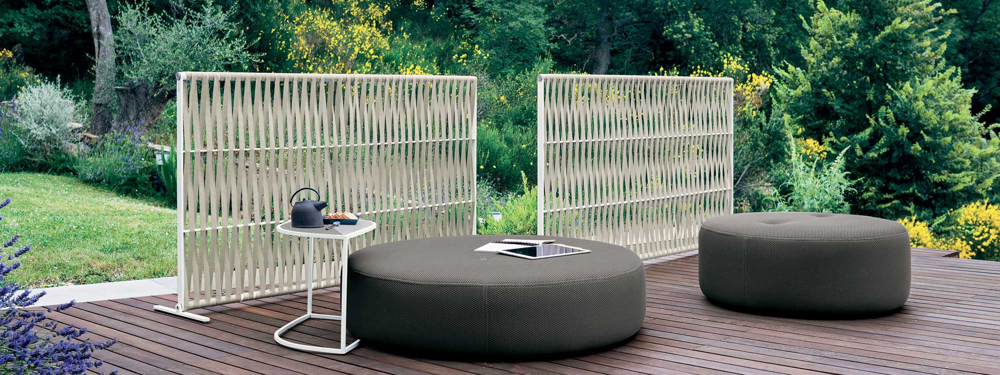 Image of milk-colored Wing outdoor screens by RODA, together with Double round outdoor pouf and Leaf minimalist garden side table