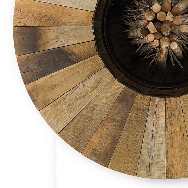 Image of aerial view of Zero wood fire pit's chestnut wood surround and burning chamber filled with fire wood ready to light, by AK47 Design, Italy.