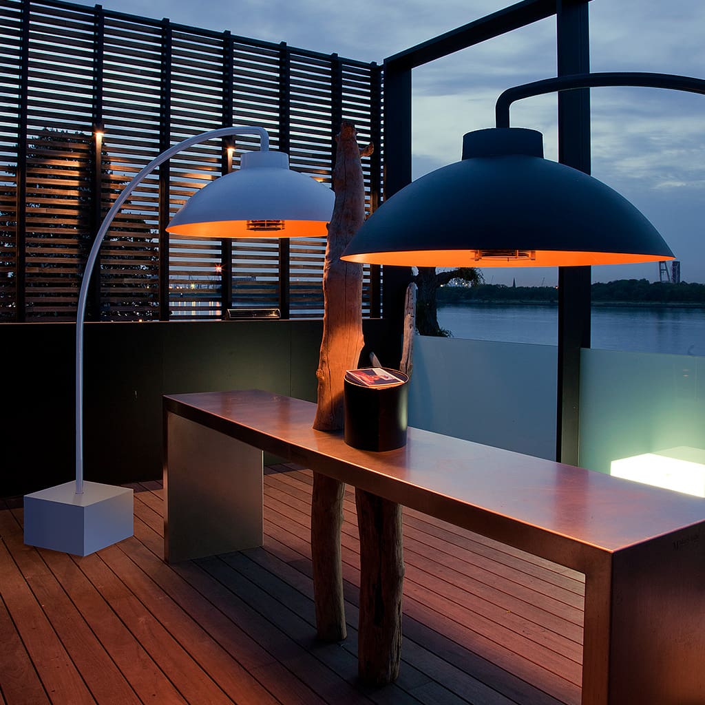 Two dome bow patio heaters in black and white on a deck overlooking the ocean