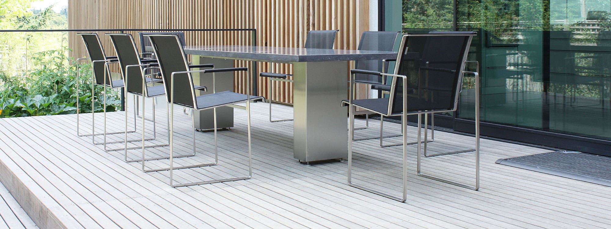 Image of installation of FueraDentro Doble minimalist garden dining table and Sillon outdoor chairs