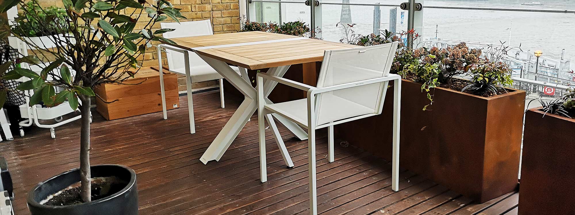 London Modern Rooftop Terrace Furniture Installation Of Traverse Folding Garden Table & Alura Stacking Garden Chairs. Royal Botania Luxury Garden Furniture.