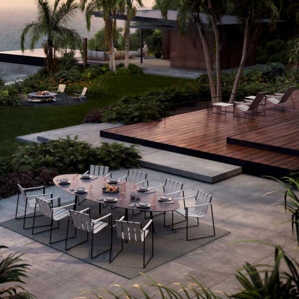 Image of elliptical Royal Botania garden table and dining chairs in tropical surrounding