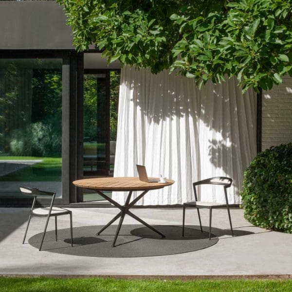 Image of Styletto garden chair and Exes circular garden table with teak top by Royal Botania on sunny terrace