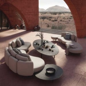 Image of Royal Botania elliptical Styletto low table and Organix sofas with arid hills in background