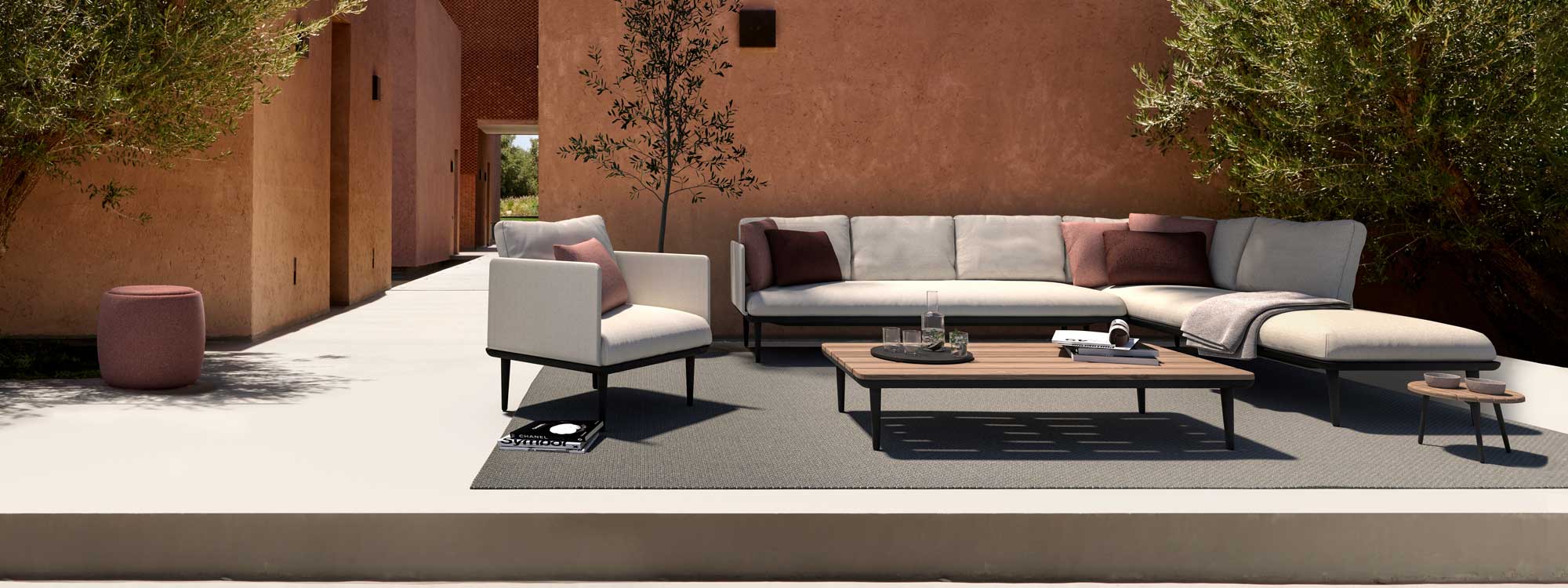 Image of Royal Botania corner sofa and lounge chair in terracotta-colored courtyard