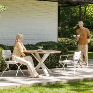 Image of white Traverse fold-down garden table and Exes chairs by Royal Botania
