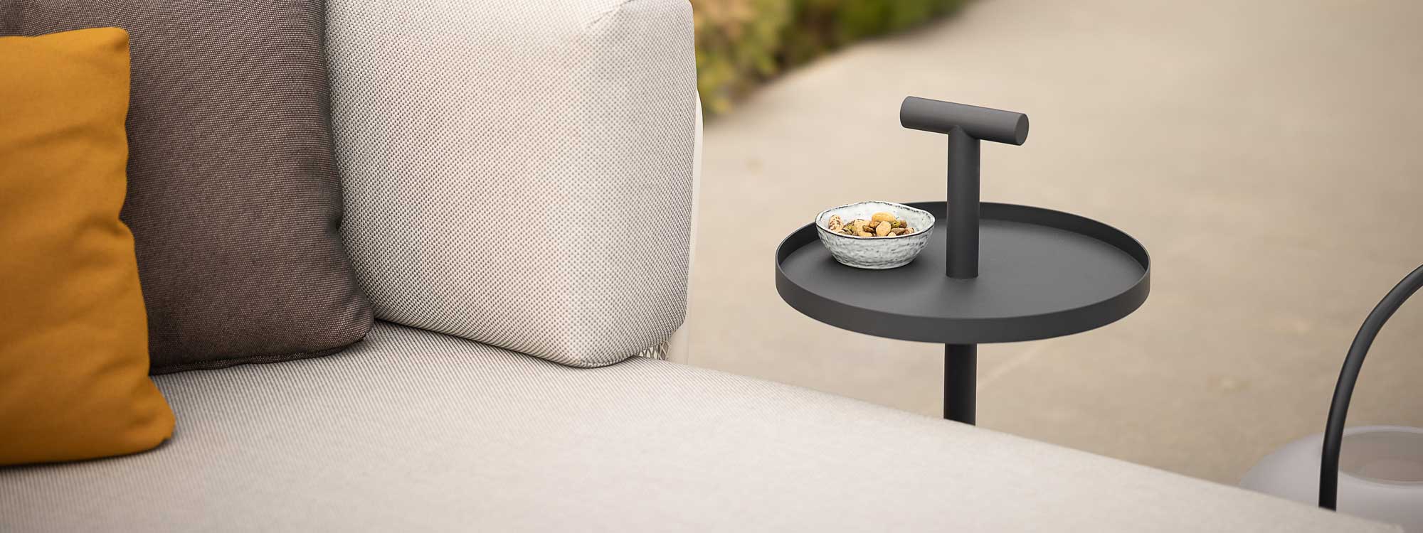 Image of Albus minimalist outdoor side table next to Baza modern garden sofa