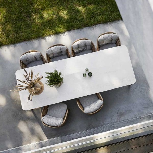 Image of Aspect ceramic garden table and natural cane Basket chairs by Cane-line garden furniture