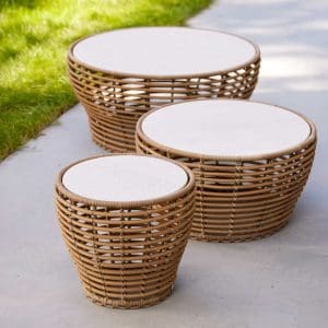 Image showing 3 different sizes of Basket low tables in natural cane and travertine ceramic by Caneline garden furniture