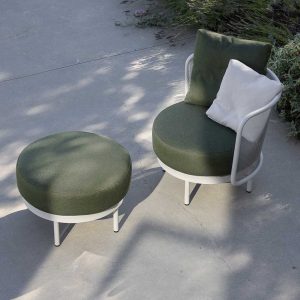 Image of Baza Club chair and round garden foot rest with white frames and green upholstery in light and shade on terrace