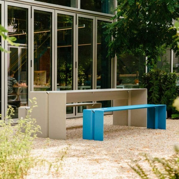 Image of The Bended light grey minimalist garden table and blue bench seat by Wunder