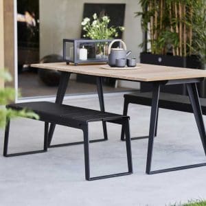 Image of Cane-line Copenhagen garden bench seat and dining table in lava-grey aluminum with teak table top