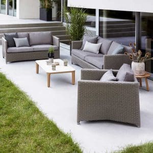 Image of Diamond taupe garden sofa and lounge chair with Aspect ceramic coffee table by Cane-line in the center