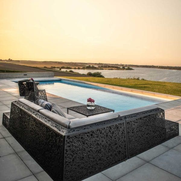 Image of rear of Bios Lounge furniture by Unknown Nordic on poolside at dusk