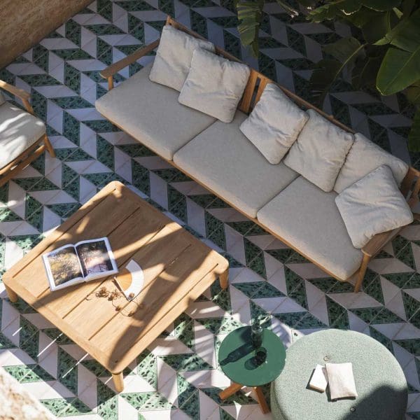 Image of aerial view of RODA Levante modern teak sofa and teak coffee table next to Double pouf and Root side table