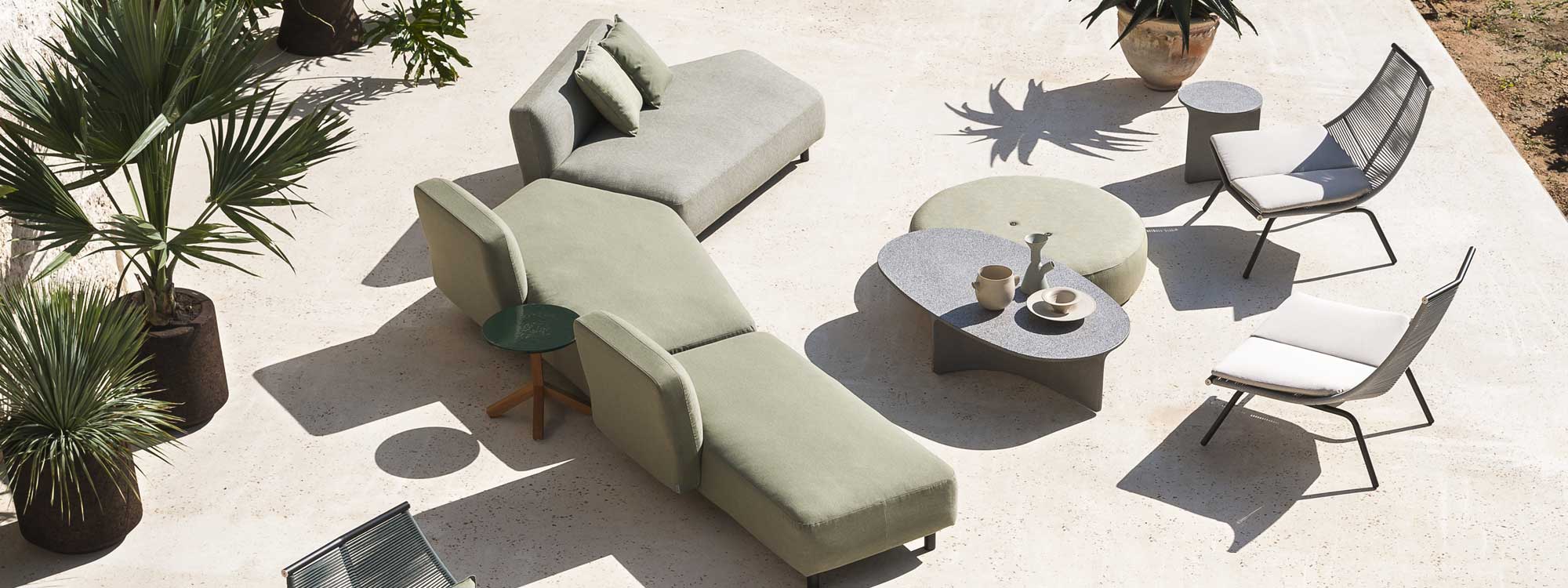 Image of RODA Mamba garden sofa with irregularly shaped lounge modules, together with Laze outdoor lounge chairs and Aspic concrete low tables