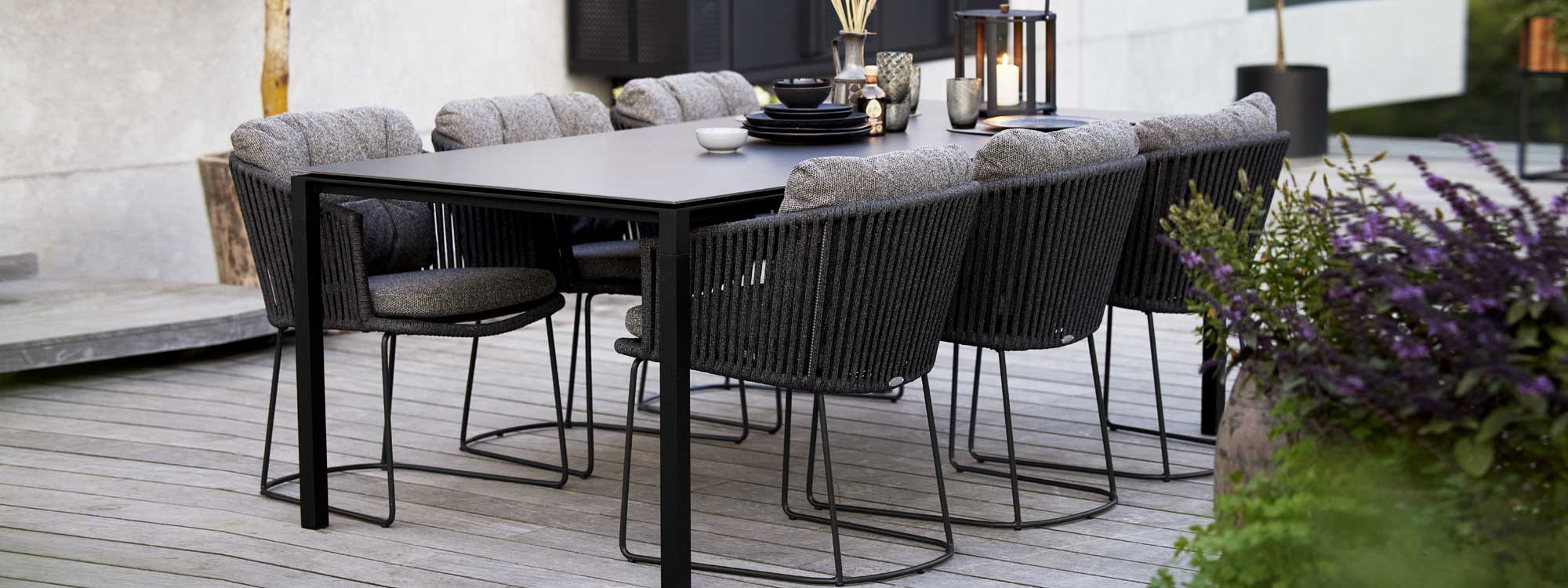 Image of dark-grey Moments garden chairs and Lava-grey Pure rectangular dining table by Cane-line