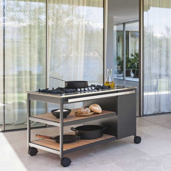 Image of RODA Norma stainless steel gas BBQ with wheels, with bread and sauce pans on the larch storage shelves