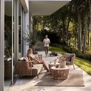 Image of Sense synthetic cane garden sofa and Basket artificial cane low table by Cane-line, Denmark