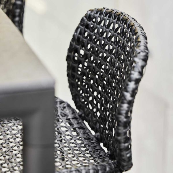 Image of detail of Drop bar table's ceramic table top and Vibe bar stool's hand-woven seat & back by Cane-line garden furniture