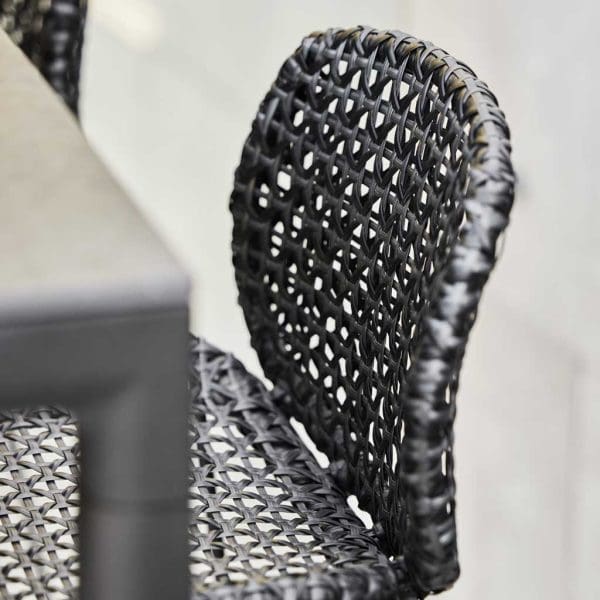Image of detail of Drop bar table's ceramic table top and Vibe bar stool's hand-woven seat & back by Cane-line garden furniture