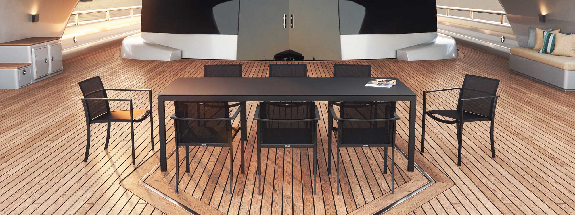 Image of black OZN55T garden chairs and black Taboela outdoor dining table on teak aft deck of superyacht