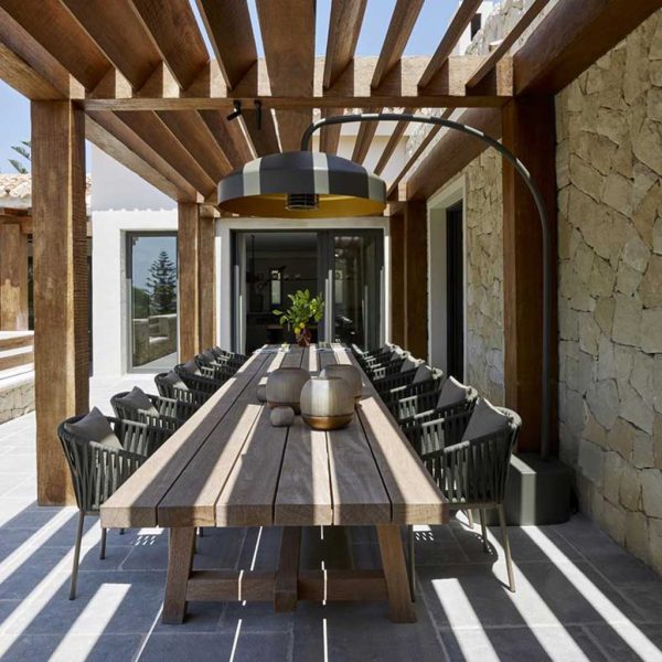 Image of pebble-colored Disc terrace heater by Heatsail above large planked teak table